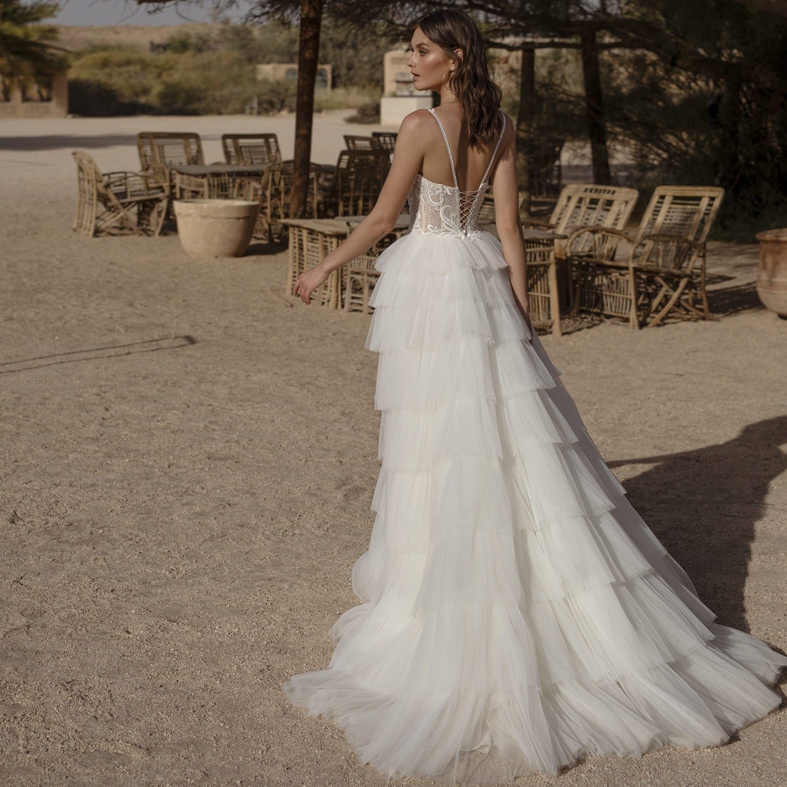 Look stunning on your wedding day in Robe Aluisa. This beautiful desert-style bridal gown features a ruffled line and sleeveless design, perfect for any wedding occasion. Crafted from luxurious fabrics, this gown will make you feel like the beautiful, blushing bride you are.