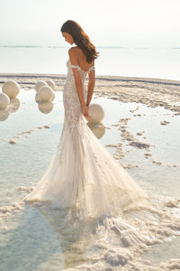 Effortlessly glide down the aisle in our stunning Robe Fearne. This elegant mermaid bridal gown is the epitome of luxury, complete with sparkling details for a chic and unique touch. Embrace your inner goddess and feel sexy and dreamy on your special day with this one-of-a-kind wedding dress.