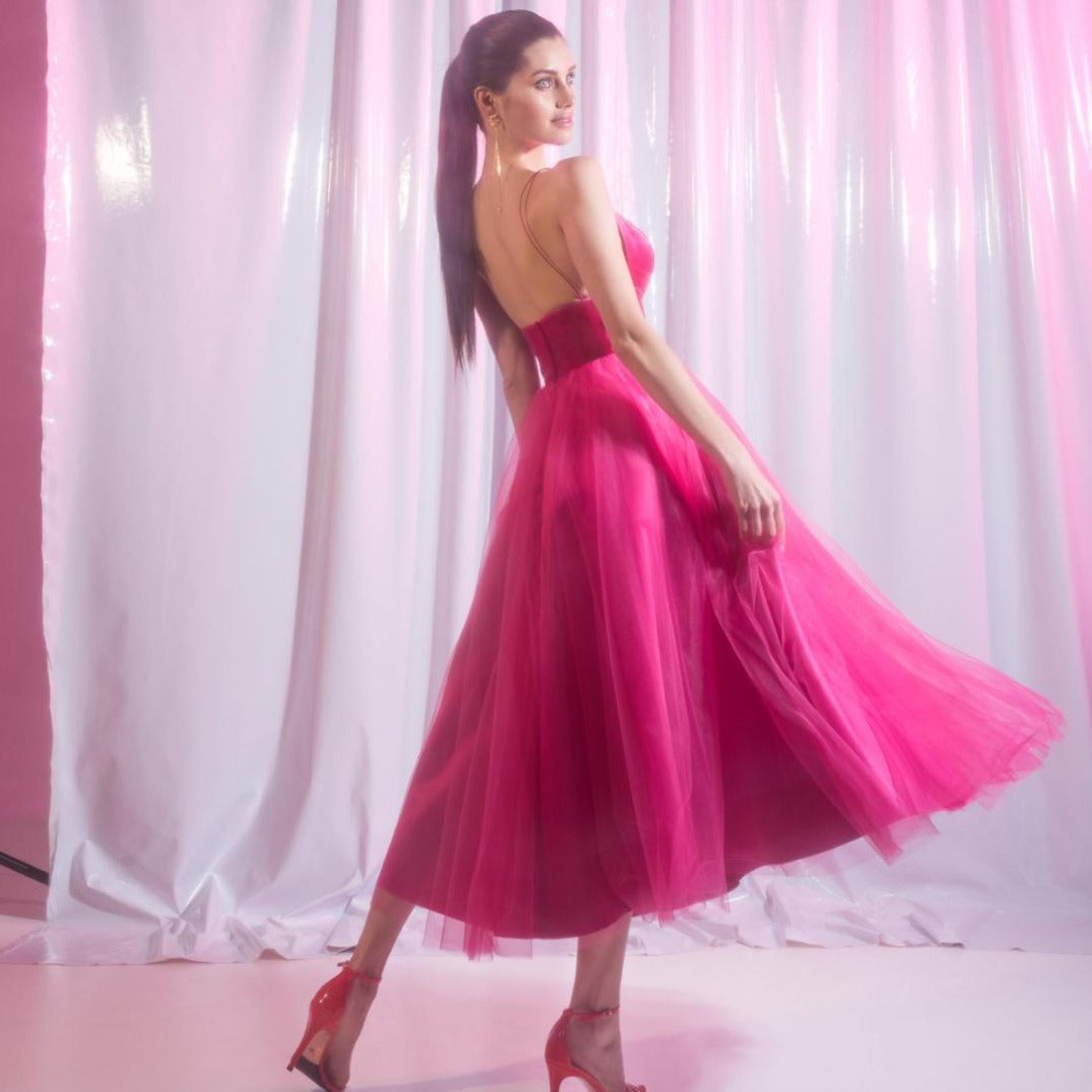 Experience the ultimate in elegance with our Robe Nirvana. This fuchsia cocktail gown features a v-neck and delicate spaghetti straps, making it the perfect choice for a night out. Indulge in luxury and make a statement with this stunning piece.