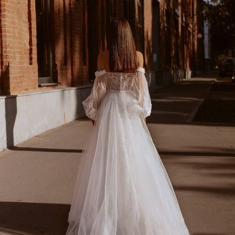 Feel like a goddess on your special day with our Robe Salomé. This elegant white bridal gown exudes chic and sophistication, making you stand out as you walk down the aisle. Feel confident and beautiful in every step, as you say "I do" in style. Elevate your wedding experience with Robe Salomé!