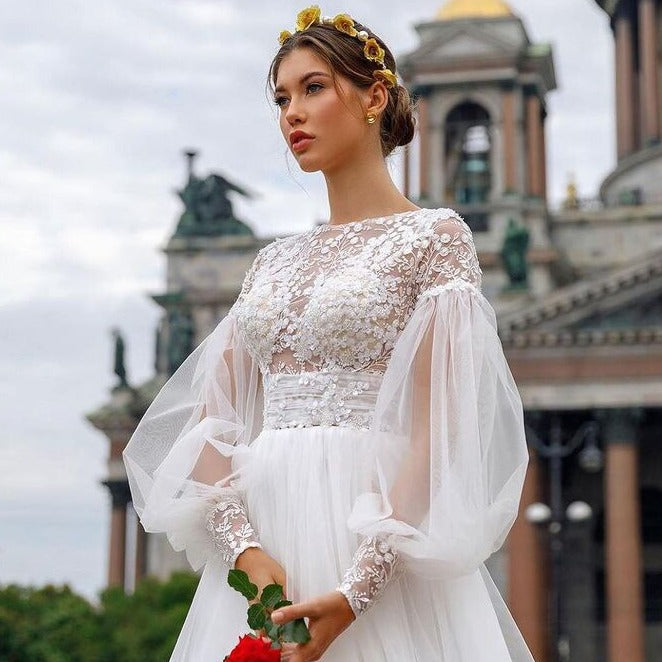 Indulge in the timeless elegance of our Robe Joelene. This chic and sophisticated bridal gown boasts exquisite embroidery, perfect for your special day. Elevate your wedding ensemble with this luxurious and exclusive piece.