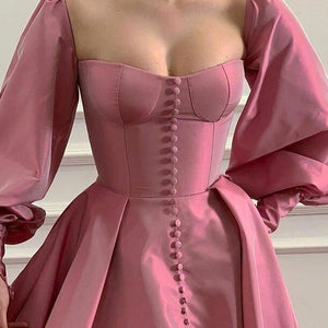 Evoke fairy tale fantasies in our Robe Eloise. The rose pink taffeta gown creates a flattering A-line silhouette with a structured bodice and lace-up back, while the gathered skirt and train exude elegance and sophistication. Complete the enchanting look with our specially designed embroidered ruffle heart gloves. Perfect for balls, weddings, and grand occasions.