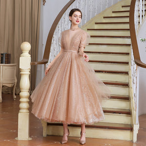 This stunning tea length dress, the Robe Tiffany, will make you feel like royalty. With its sparkling design, it exudes a princess-like elegance that is sure to turn heads. Perfect for any formal event, this dress is both stylish and sophisticated. Channel your inner princess with the Robe Tiffany.