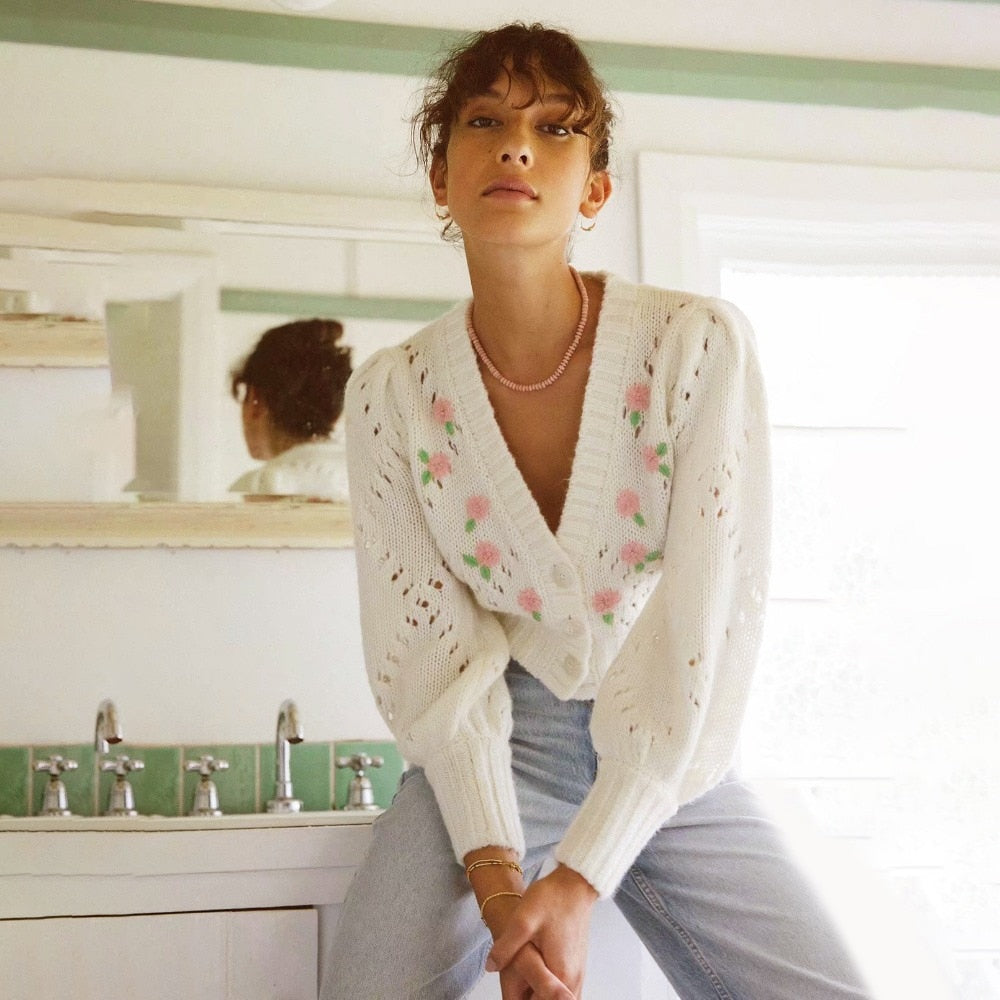 This white cardigan features delicate flower embroidery, adding a touch of elegance to any outfit. The intricate design is sure to catch the eye and elevate your style. Made with high-quality materials, this Jacklena cardigan is both fashionable and functional.