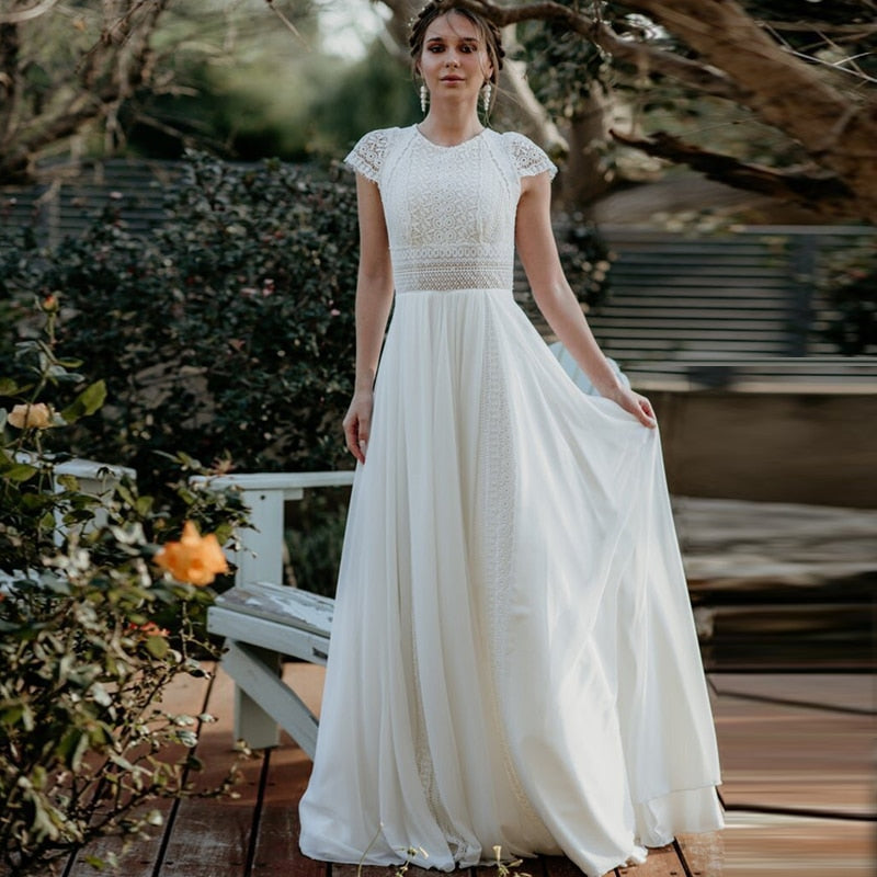 Indulge in pure luxury with the Robe Anastasie. Made with delicate white lace, this elegant gown exudes sophistication and grace. Perfect for a simple yet stunning wedding, it will make you feel like a true bride on your special day. Elevate your wedding look with this exclusive piece.