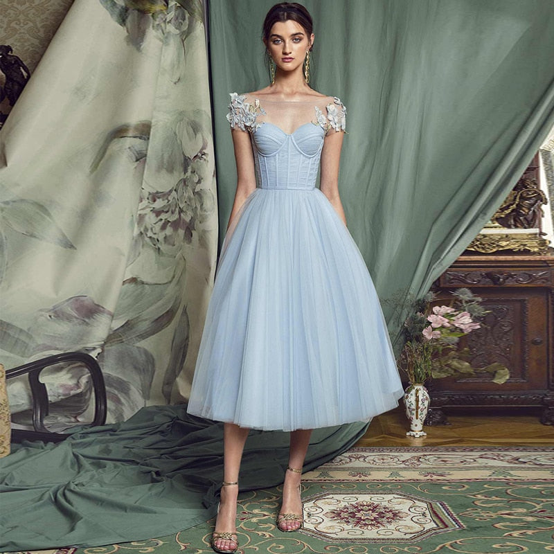 Make a statement in the elegant and sophisticated Robe Esme. Featuring delicate appliques and a lace-up back, this sky blue evening dress is perfect for any occasion. Its tea length design adds a touch of charm and versatility. Embrace your inner fashionista with Robe Esme.