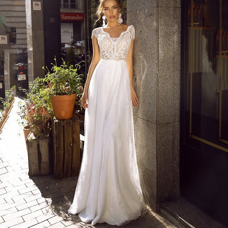 Introducing the Robe Minna, a stunning white bridal gown featuring intricate embroidery. This elegant dress combines traditional craftsmanship with modern design, creating a timeless and sophisticated look. Made with high-quality materials, the Robe Minna is the perfect choice for any bride looking for a refined and beautiful wedding dress.