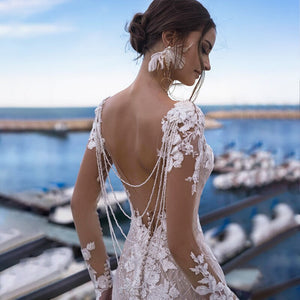 Attain elegance and timeless beauty with Robe Ethel! This unique mermaid gown features alluring lace appliques and sparkling ivory bridal gown details, making it the perfect choice for any bride looking to add a touch of glamour to her special night!