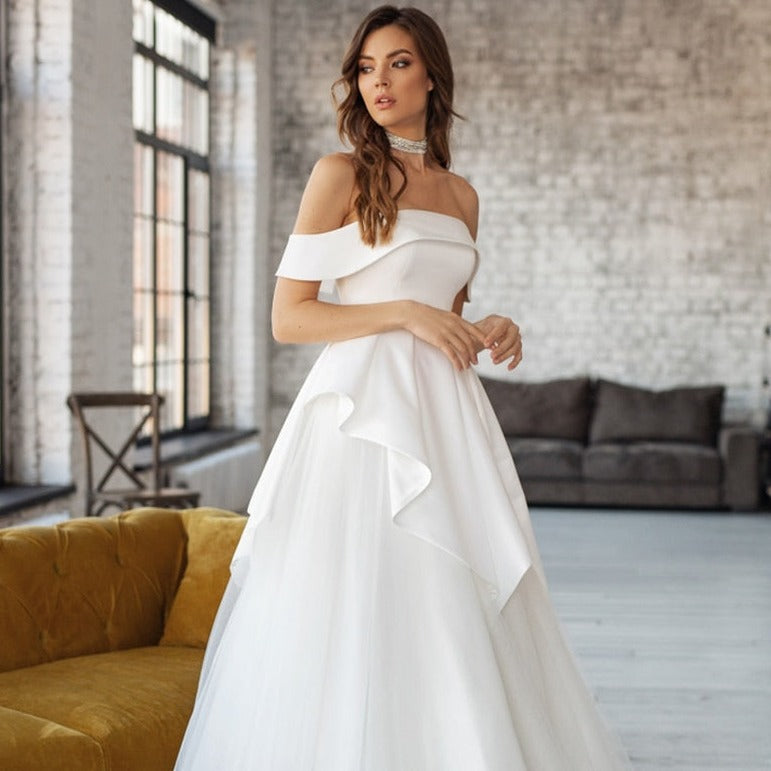 Elevate your bridal experience with the bold and daring Robe Nabhya. Its sleek white satin design will make you feel like a true risk-taker as you walk down the aisle. With its luxurious material and striking silhouette, you'll surely make a statement on your special day.