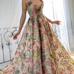 Experience the beauty of a flower field with our Dreamy Scarlet Gown. Made from printed organza, this gown features delicate handmade embroidered blooms along the shoulder straps. A luxurious velvet belt defines the waist, creating a flattering silhouette. Let this gown transport you to a dreamy garden, wherever you may go.