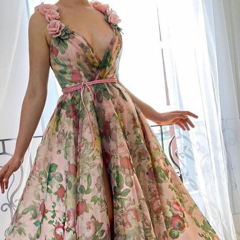 Experience the beauty of a flower field with our Dreamy Scarlet Gown. Made from printed organza, this gown features delicate handmade embroidered blooms along the shoulder straps. A luxurious velvet belt defines the waist, creating a flattering silhouette. Let this gown transport you to a dreamy garden, wherever you may go.