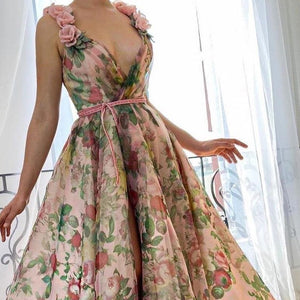 Experience the beauty of a flower field with our Dreamy Scarlet Gown. Made from printed organza, this gown features delicate handmade embroidered blooms along the shoulder straps. A luxurious velvet belt defines the waist, creating a flattering silhouette. Let this gown transport you to a dreamy garden, wherever you may go.