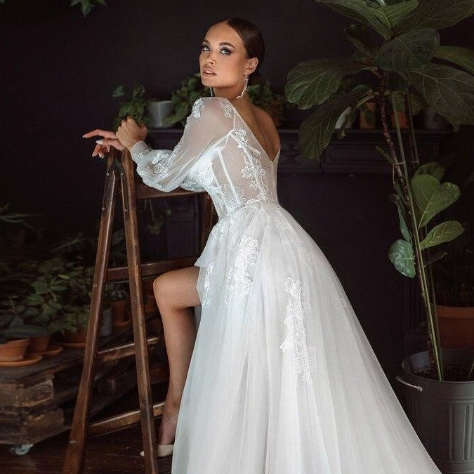 Indulge in the timeless elegance of the Robe Danica. Designed with exquisite bridal lace, this white gown exudes sophistication and grace. Perfect for any special occasion, it will make you feel like the belle of the ball, radiating beauty and sophistication. Experience luxury and grace in every step.