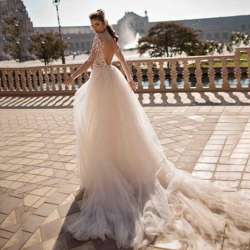 Introducing the Ailene Robe - a stunning bridal gown perfect for the chic and sophisticated bride. Its exquisite design features a long train, sure to make a statement on your special day. With its luxurious look and feel, this dress will elevate your wedding to new heights.