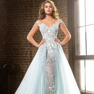 Expertly crafted with intricate blue illusion lace and beaded appliques, the Robe Marigold is a stunning prom dress for a luxurious evening. The flowing court train adds an elegant touch while showcasing your figure. Make a statement in this long, glamorous gown.