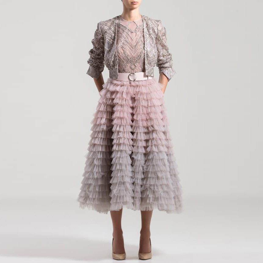 Elevate your style with the Jupe Ealla. This premium puffy tulle skirt in dusty grey adds a touch of sophistication to any outfit. With its airy texture and subtle color, it's a timeless piece that exudes elegance and luxury. Perfect for a day at the opera or a night out on the town.