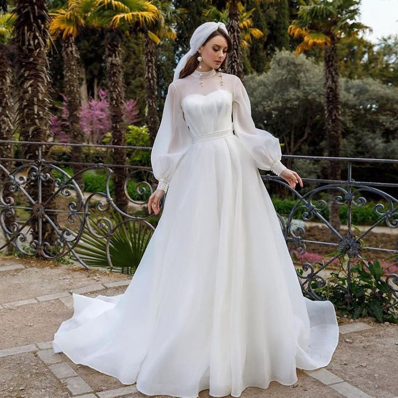 Transform into an ethereal vision with our Robe Iqra. This elegant chic bridal gown features long sleeves and a flattering A-line silhouette, making it the perfect choice for any bride. Walk down the aisle in style and grace with its luxurious design and feel like a true work of art on your special day.