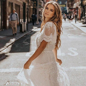 Effortlessly elegant, the Robe Andrea is a seductive white lace maxi dress perfect for any occasion. Featuring a cross semi-sheer plunge v-neck and delicate short sleeves, it enhances your curves while exuding a stylish and chic vibe. Be the center of attention and feel confident in this sexy dress.