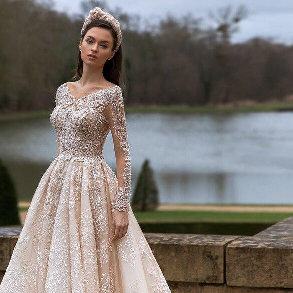 "Capture hearts and minds in the Robe Blaan! This crystal embellished gown is a dreamy lace crafted masterpiece, evoking a romantic ambience perfect for any bridal occasion. Stand out and make a statement with this bold and captivating piece. Take the risk and be the shining star of your special day!"