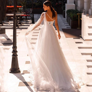 "Get ready to walk down the aisle in style with our Robe Mazelina - the perfect elegant and chic bridal wedding gown. Make a stunning statement on your special day with this must-have gown. Say "I do" to the dress that will have all eyes on you. Cheers to your happily ever after!"