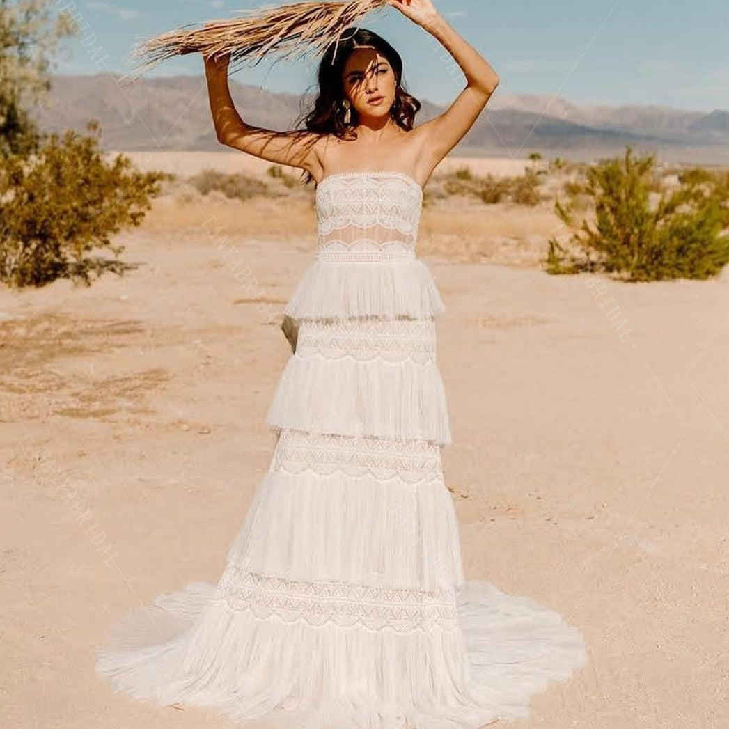 Indulge in sophistication and grace with our Robe Elisabett. This elegant boho ruffle wedding bridal dress stuns with its timeless beauty and delicate details. Perfect for the modern bride who appreciates a touch of whimsy, it will make you feel like a true work of art on your special day.