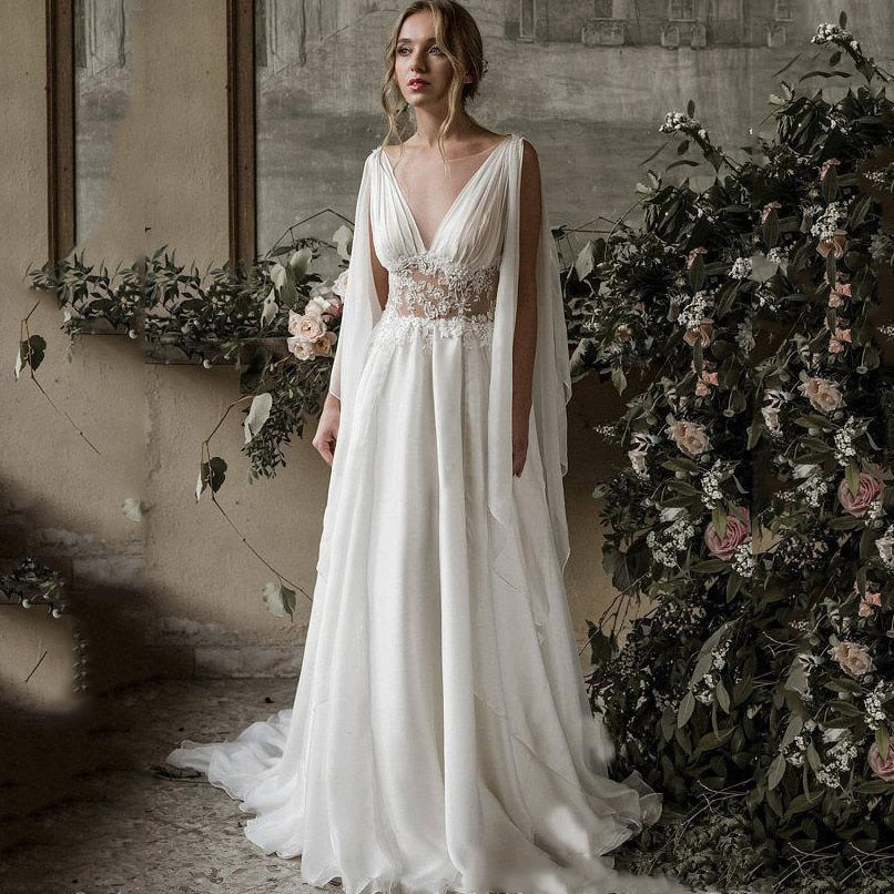 Indulge in the beauty of our Robe Rhian, a stunning boho-inspired bridal gown. Crafted with intricate details, this pure white robe exudes elegance and grace, perfect for any bride looking to make a statement on her special day. Experience the luxury of our Rhian, a true masterpiece in the world of bridal fashion.