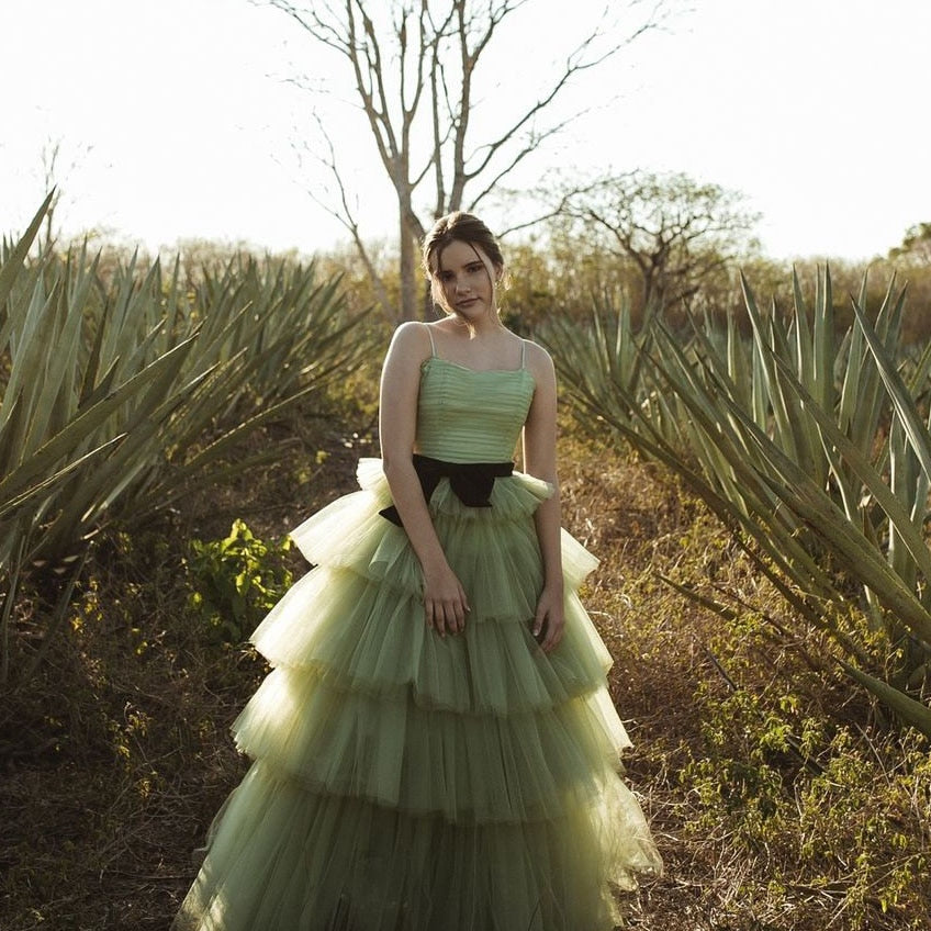 Indulge in the ethereal beauty of the Robe Manaya tulle gown. This artistic green dress will captivate any audience with its delicate fabric and mesmerizing color. Elevate your style and make a statement with this stunning garment.