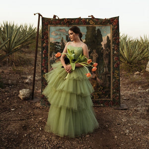 Indulge in the ethereal beauty of the Robe Manaya tulle gown. This artistic green dress will captivate any audience with its delicate fabric and mesmerizing color. Elevate your style and make a statement with this stunning garment.