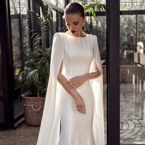 Experience elegance and beauty with our Robe Hettie. This cape gown bridal marriage dress is perfect for your special day. With its exquisite design, you'll feel like royalty as you walk down the aisle. Make your wedding day even more magical with our stunning Robe Hettie.