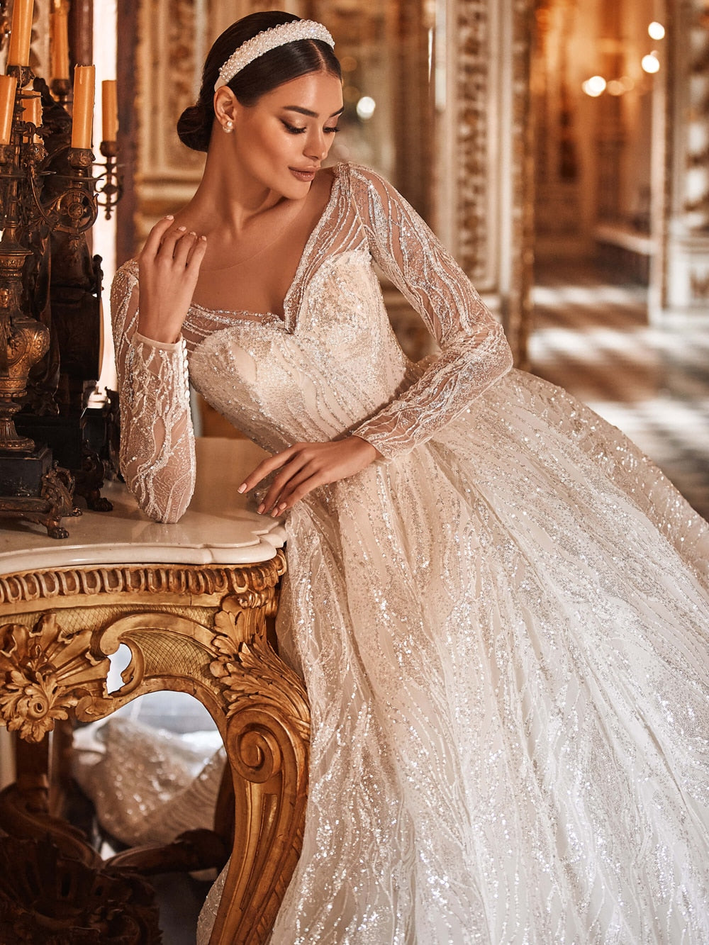 Elevate your bridal style with the Anasofia Sleeve Illusion Back Wedding Dress. Sparkle effortlessly with stunning glitter details, while the illusion back adds a touch of sophistication. Made with high-quality materials, this gown offers comfort and a flattering fit for any body type. Perfect for your dreamy ceremony, it exudes elegance and charm.