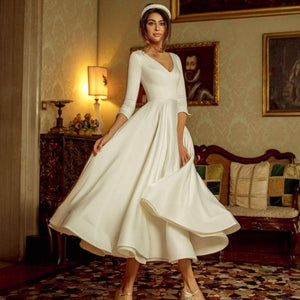 Indulge in the elegant and sophisticated design of the Robe Leah. This tea length bridal satin chic dress is the epitome of luxury, crafted with the finest materials for a flawless fit. Embrace your inner doll and make a statement on your special day.