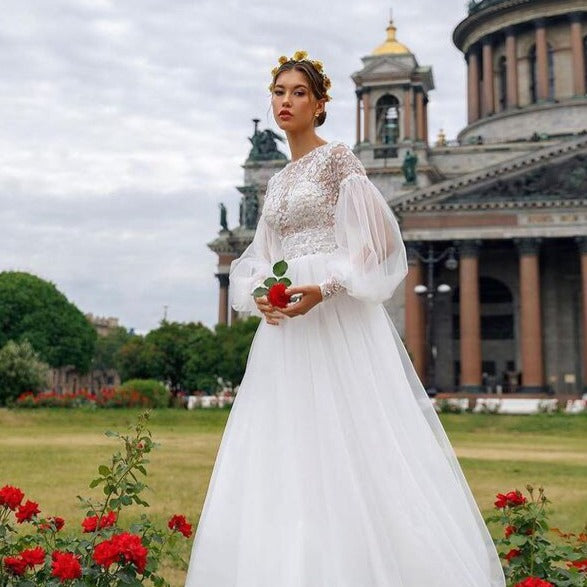 Indulge in the timeless elegance of our Robe Joelene. This chic and sophisticated bridal gown boasts exquisite embroidery, perfect for your special day. Elevate your wedding ensemble with this luxurious and exclusive piece.