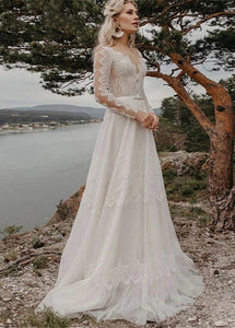 Introducing the Robe Elize, a sophisticated and elegant bridal dress perfect for your beach bohemian wedding. Featuring beautiful lace applique, a transparent long sleeve design, and a chic V-neckline, this plus size dress will make you feel like a ethereal goddess on your special day.