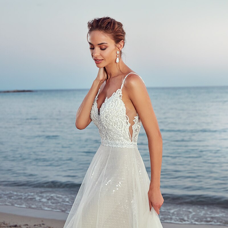 Indulge in luxury and grace with our Robe Emmeline. This elegant white gown is the epitome of chic and the perfect choice for any bridal occasion. Embody sophistication and timeless beauty with its flowing silhouette and intricate details. Elevate your wedding dress game with the Robe Emmeline.