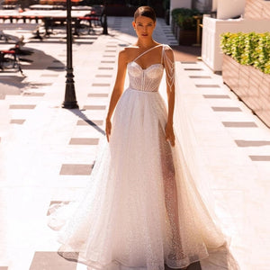 "Get ready to walk down the aisle in style with our Robe Mazelina - the perfect elegant and chic bridal wedding gown. Make a stunning statement on your special day with this must-have gown. Say "I do" to the dress that will have all eyes on you. Cheers to your happily ever after!"