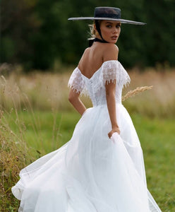 "Unleash your inner boho beauty with our Robe Franchele! This stunning A-line wedding dress features a sweetheart neckline, open back, and delicate embroidery lace. Complete with fringe arm bands for a touch of whimsy. Let your free-spirited style shine on your special day!"