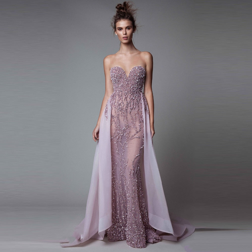 Effortlessly turn heads in the Robe Eadouin. Detachable sleeveless mermaid style and sparkling purple gown create a look of pure elegance and luxury. Feel like a goddess and wow at any special event with this show-stopping gown!