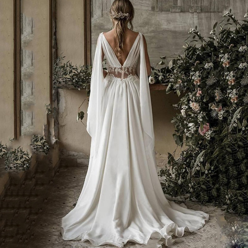 Indulge in the beauty of our Robe Rhian, a stunning boho-inspired bridal gown. Crafted with intricate details, this pure white robe exudes elegance and grace, perfect for any bride looking to make a statement on her special day. Experience the luxury of our Rhian, a true masterpiece in the world of bridal fashion.