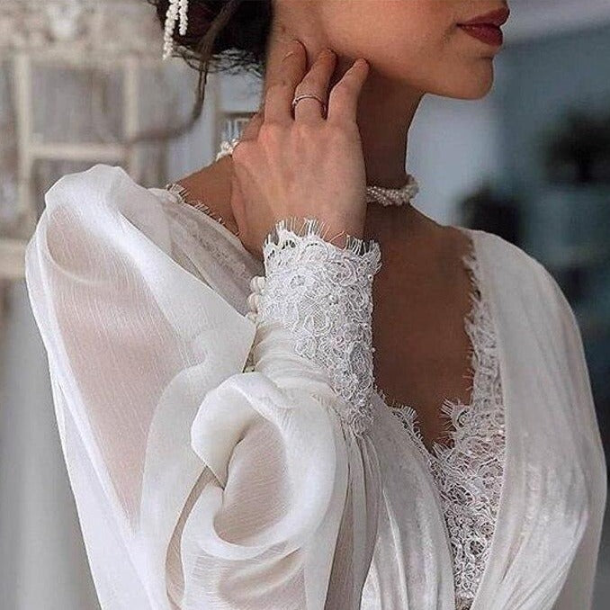 Dress to impress on your big day with the Robe Tiziana. This elegant white lace dress is perfect for any bride looking for a touch of sophistication. With its intricate lace design, it's sure to turn heads as you walk down the aisle. Get ready to say 'I do' in style.&nbsp;