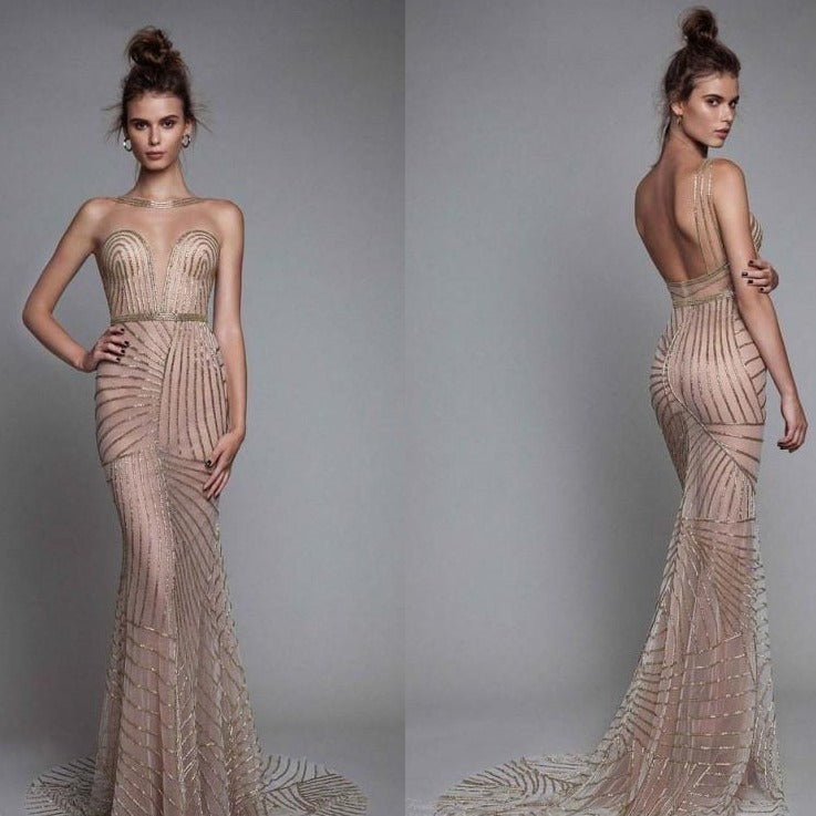 Dare to dazzle in our Robe Fawna, a nude tulle mermaid dress adorned with sparkling crystal beads. Featuring a transparent design that exudes sensuality, this custom-fitted evening gown is the perfect choice for a bold and adventurous night out!