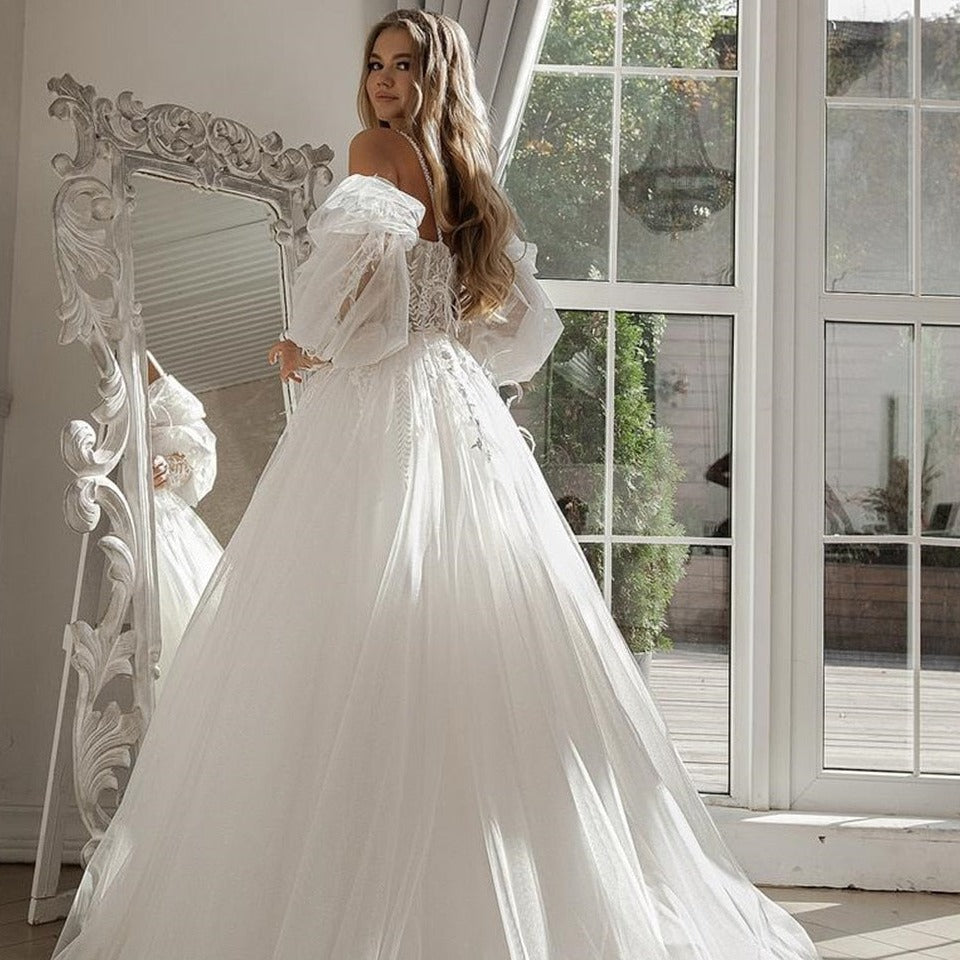 Make a stunning entrance on your special day with our Robe Pamina. This beautiful tulle bridal gown will make you feel like a princess as you walk down the aisle. Its delicate fabric and elegant design will leave everyone in awe. Look and feel your best with our Robe Pamina.