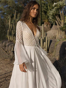 Elevate your wedding look to new levels of adventure with the Robe Esmira. This elegant lace boho style dress exudes confidence and dares you to take risks. Glide down the aisle and create a lasting impression with this bold and inspiring wedding dress.