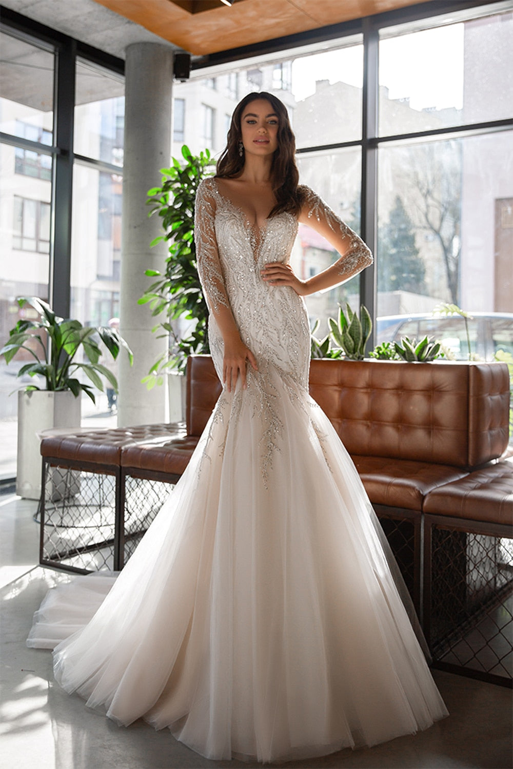 Crafted with elegance and sparkle, the Robe Carlyne is a stunning mermaid wedding gown. The chic and shiny appliques add a touch of sophistication, making it the perfect choice for your special day. Elevate your bridal look with this beautifully crafted dress.