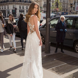 Embrace elegance with our Robe Eira dress. This stunning A-line lace dress features a deep V-neckline and delicate lace appliques, perfect for a beach wedding or any special occasion. With its vintage-inspired design and flattering fit, you'll feel sexy and confident all day long.