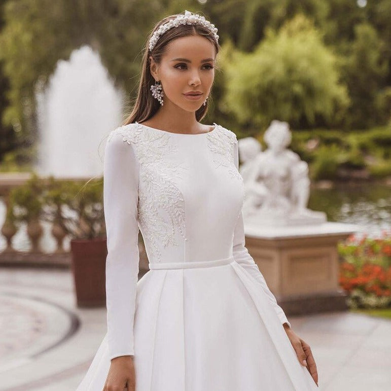 Channel your inner brave princess in the Eli wedding dress! With its charming long sleeves and elegant design, this dress will make you feel like royalty on your special day. Take a risk and stand out in this stunning gown.