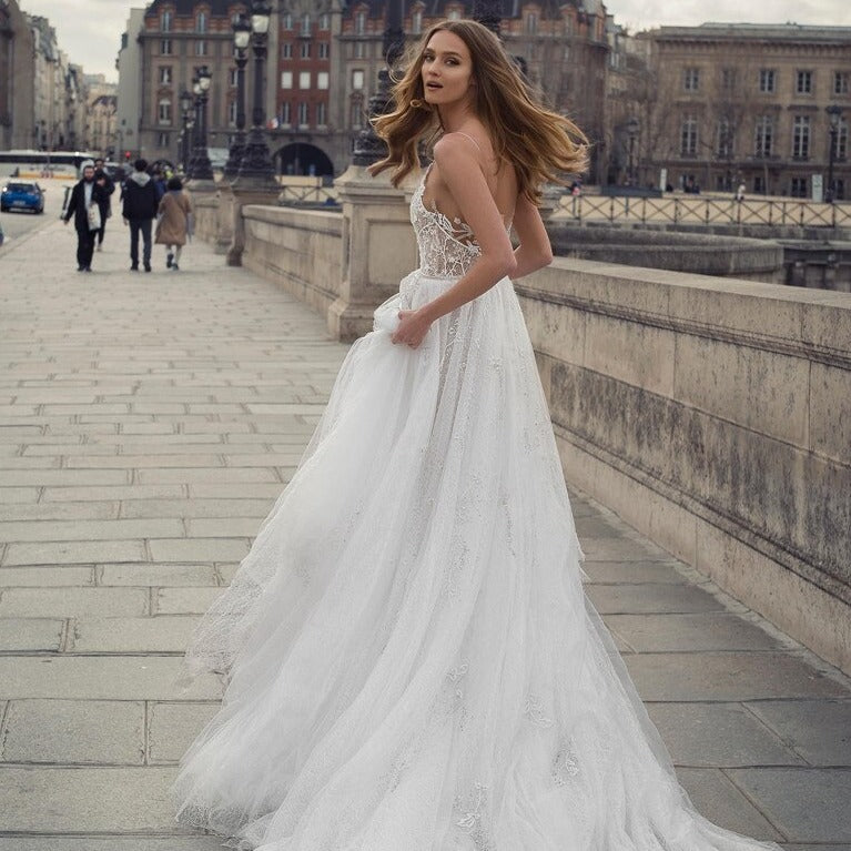 Get ready to boho down the aisle in the Robe Gladyce! This backless wedding dress features a sexy spaghetti neckline with intricate lace appliques and sparkling beads that will have you flowering with style on your special day. Get your groove on with this bohemian beauty!