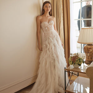 Robe Blanche, the ultimate bridal gown for your special day. Crafted with luxurious materials, this dress features stunning ivory lace details, as well as beautiful cascading ruffles for an extra-special look. Make your day memorable in this exquisite gown.