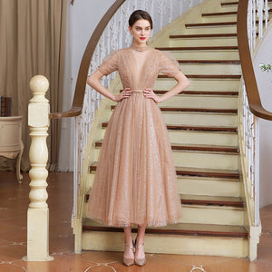 This stunning tea length dress, the Robe Tiffany, will make you feel like royalty. With its sparkling design, it exudes a princess-like elegance that is sure to turn heads. Perfect for any formal event, this dress is both stylish and sophisticated. Channel your inner princess with the Robe Tiffany.