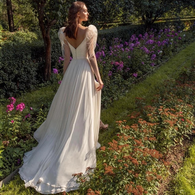 Indulge in the whimsical romance of our Robe Zowey. This elegant fairy bridal gown will make you feel like a magical goddess on your special day. With its flowing fabric and delicate design, you'll be the epitome of beauty and grace as you walk down the aisle. Add a touch of fantasy to your wedding and enchant your guests.