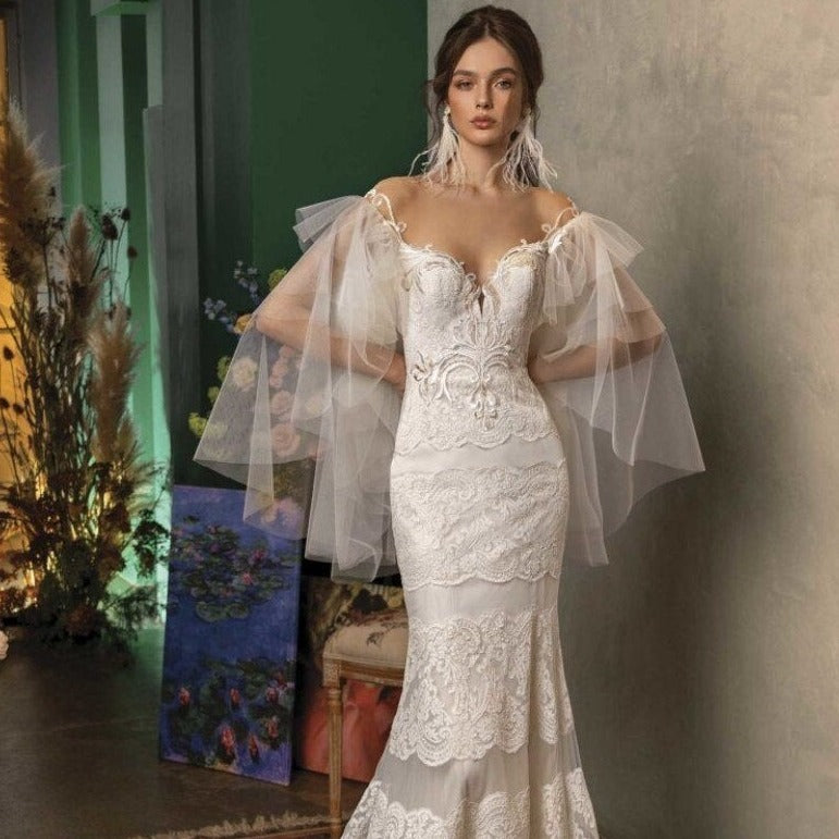 Introducing the Robe Bernadene, a chic and elegant lace gown with beautiful white embroidered butterfly sleeves. This sophisticated design will elevate your style and make you feel confident and graceful. Perfect for any special occasion, this gown will surely turn heads and make you stand out.